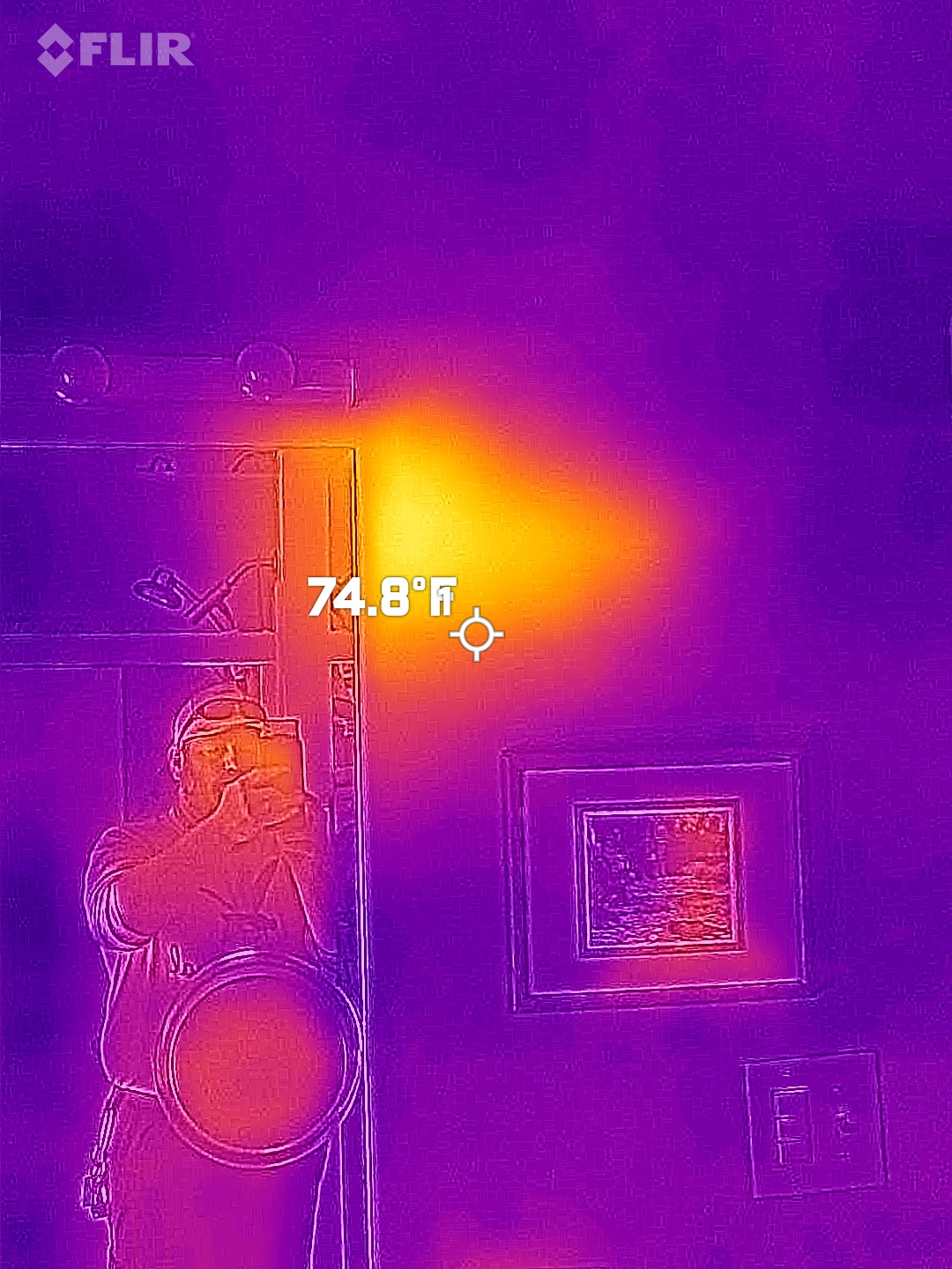 thermal image taken using an FLIR camera showing a heat spot on a wall